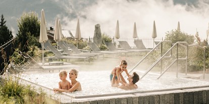 Luxusurlaub - Tiroler Oberland - Familie im Outdoor-Whirlpool - Schlosshotel Fiss